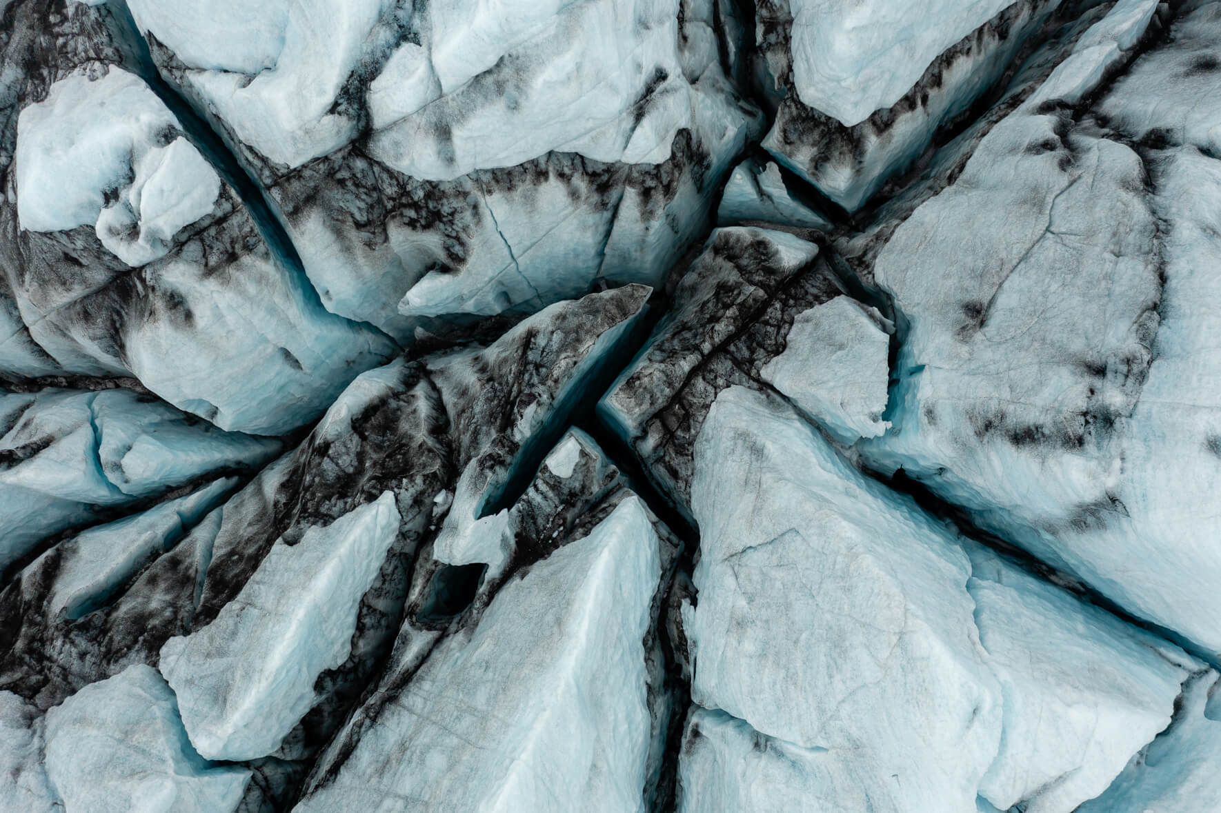 Aerial view of Breiðamerkurjökull glacier in Iceland with deep and dark crevasses