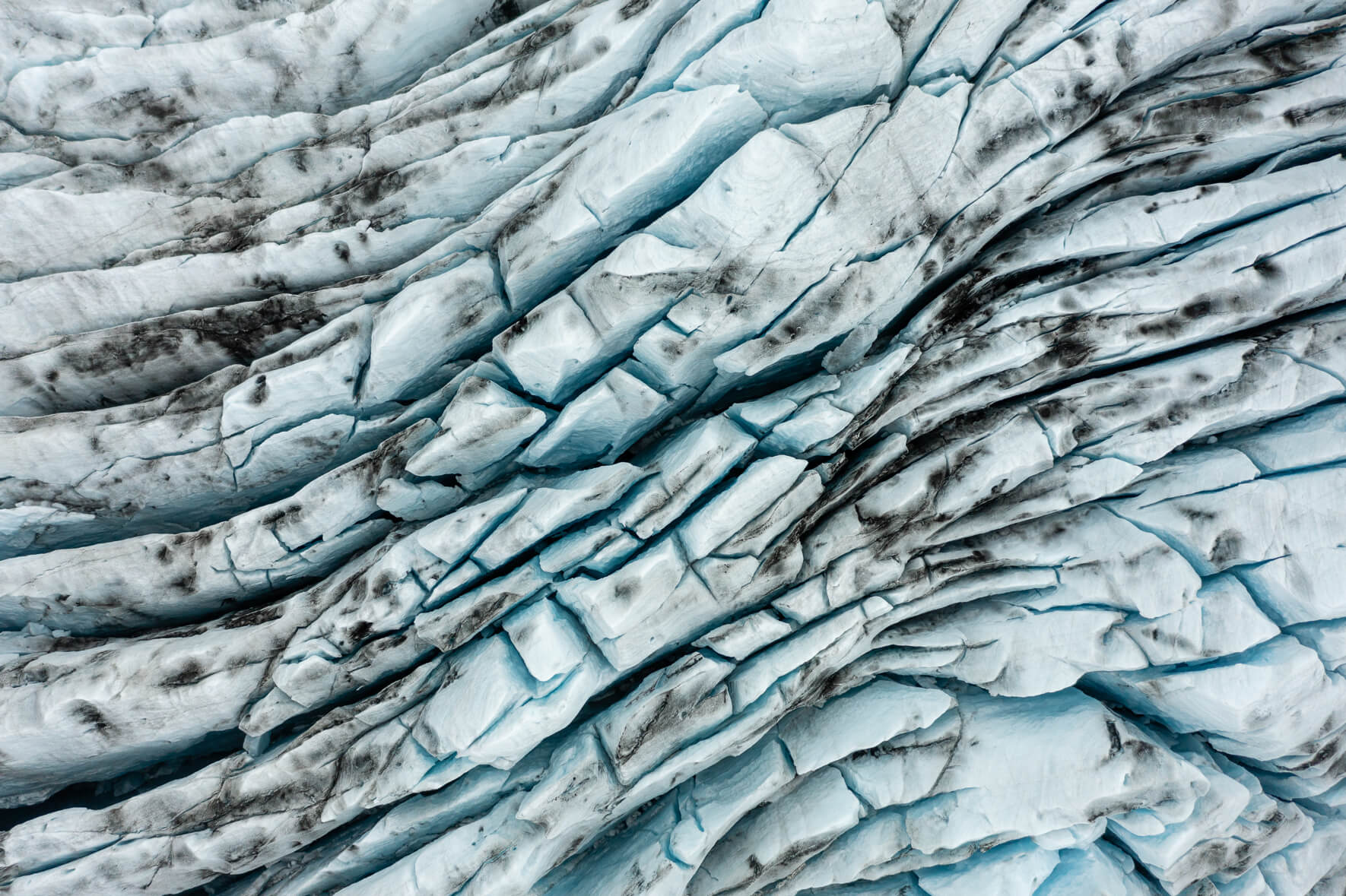 Aerial view of Breiðamerkurjökull glacier in Iceland with deep crevasses