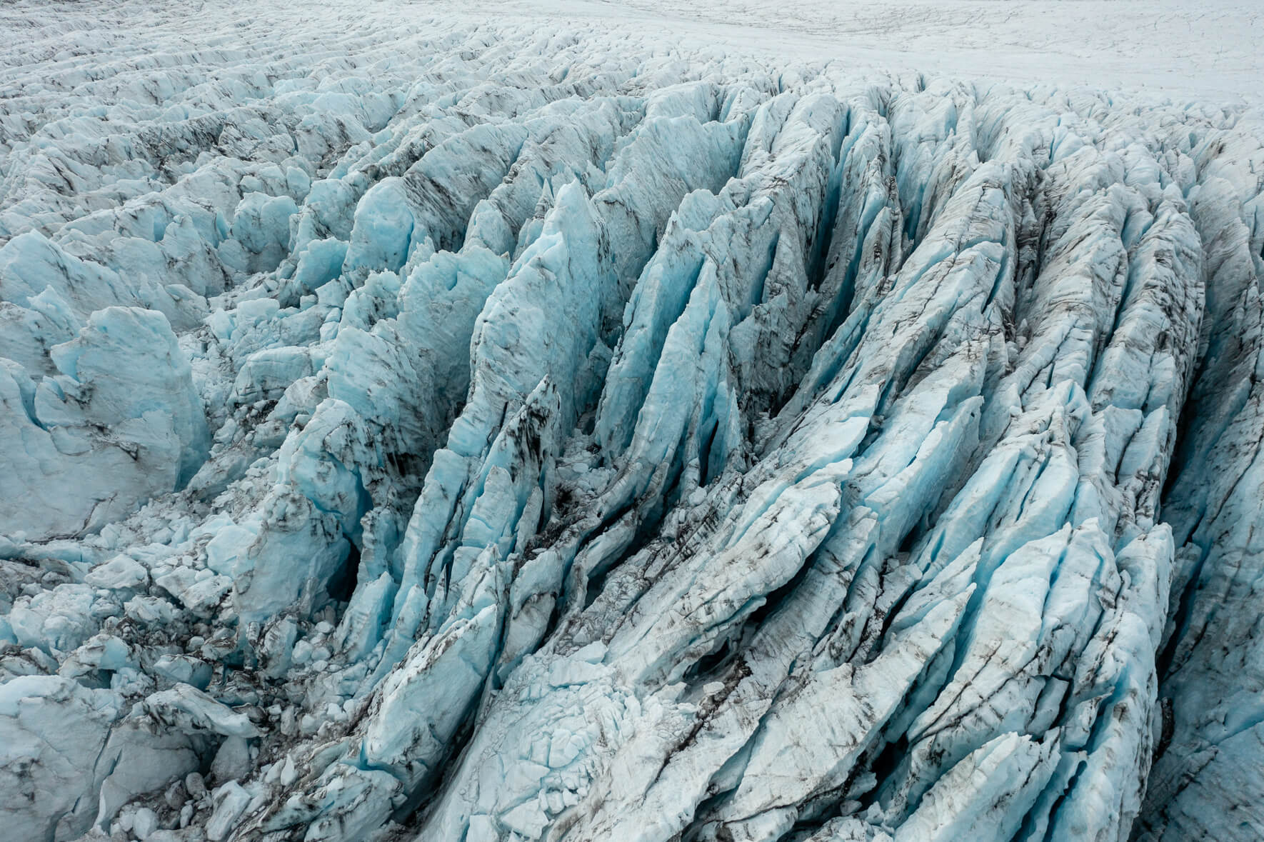 Aerial view of Breiðamerkurjökull glacier in Iceland with deep and dark crevasses