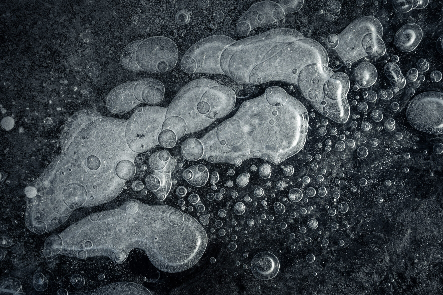 Abstract macro photography of air bubbles trapped in dark ice