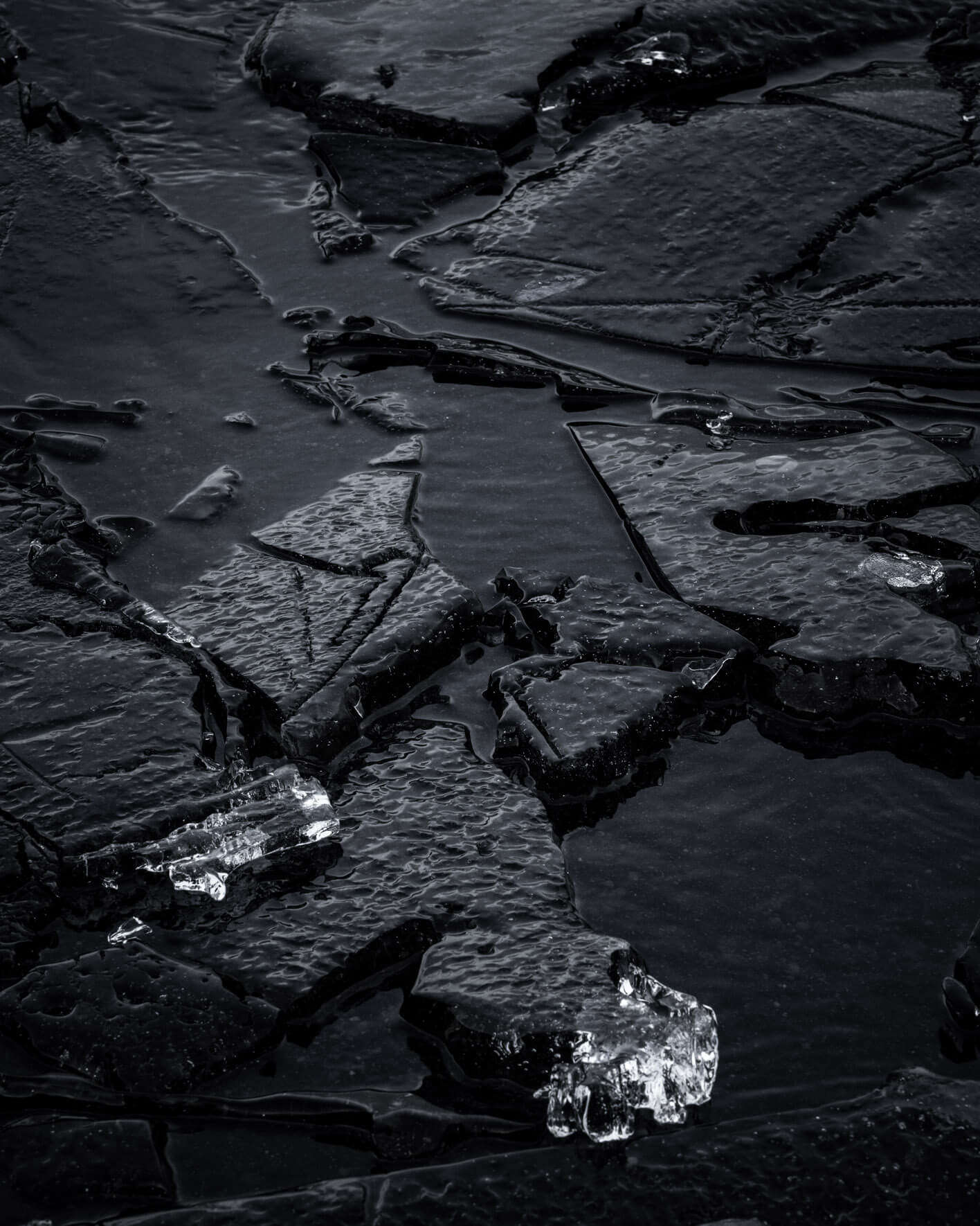 Close-up of dark ice formations on the shores of Lake Kleifarvatn in Iceland