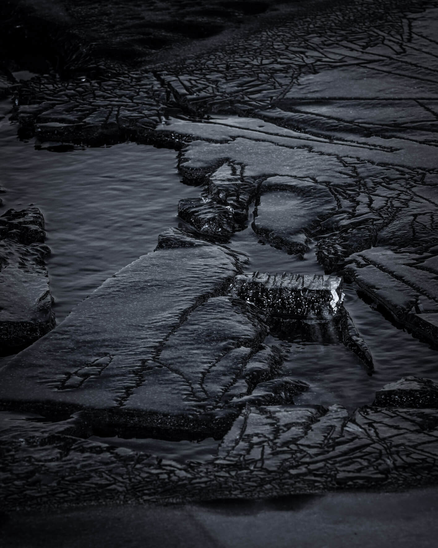 Abstract textures of a frozen lake ice in Iceland with water