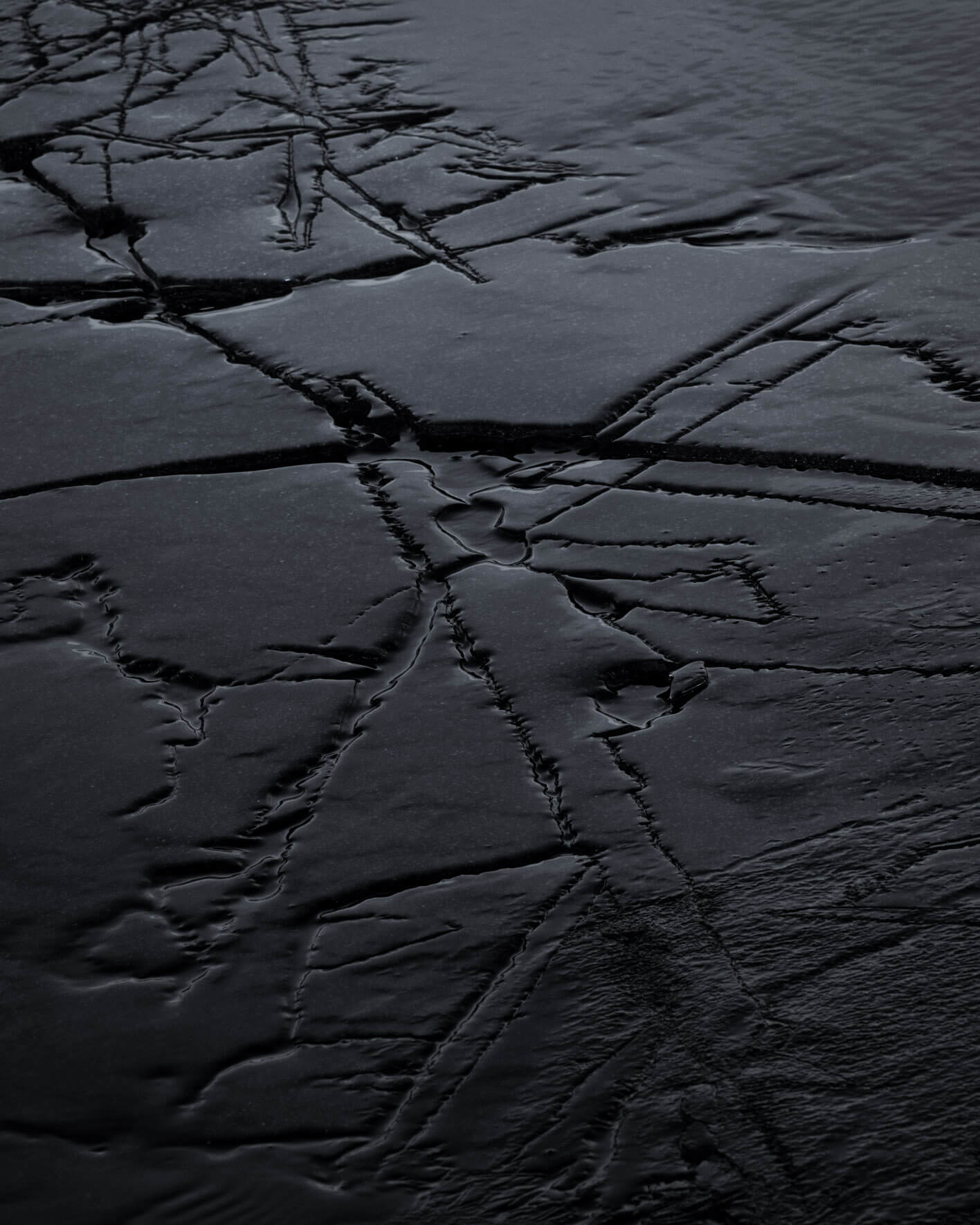 Close-up of dark ice formations on the shores of Lake Kleifarvatn in Iceland