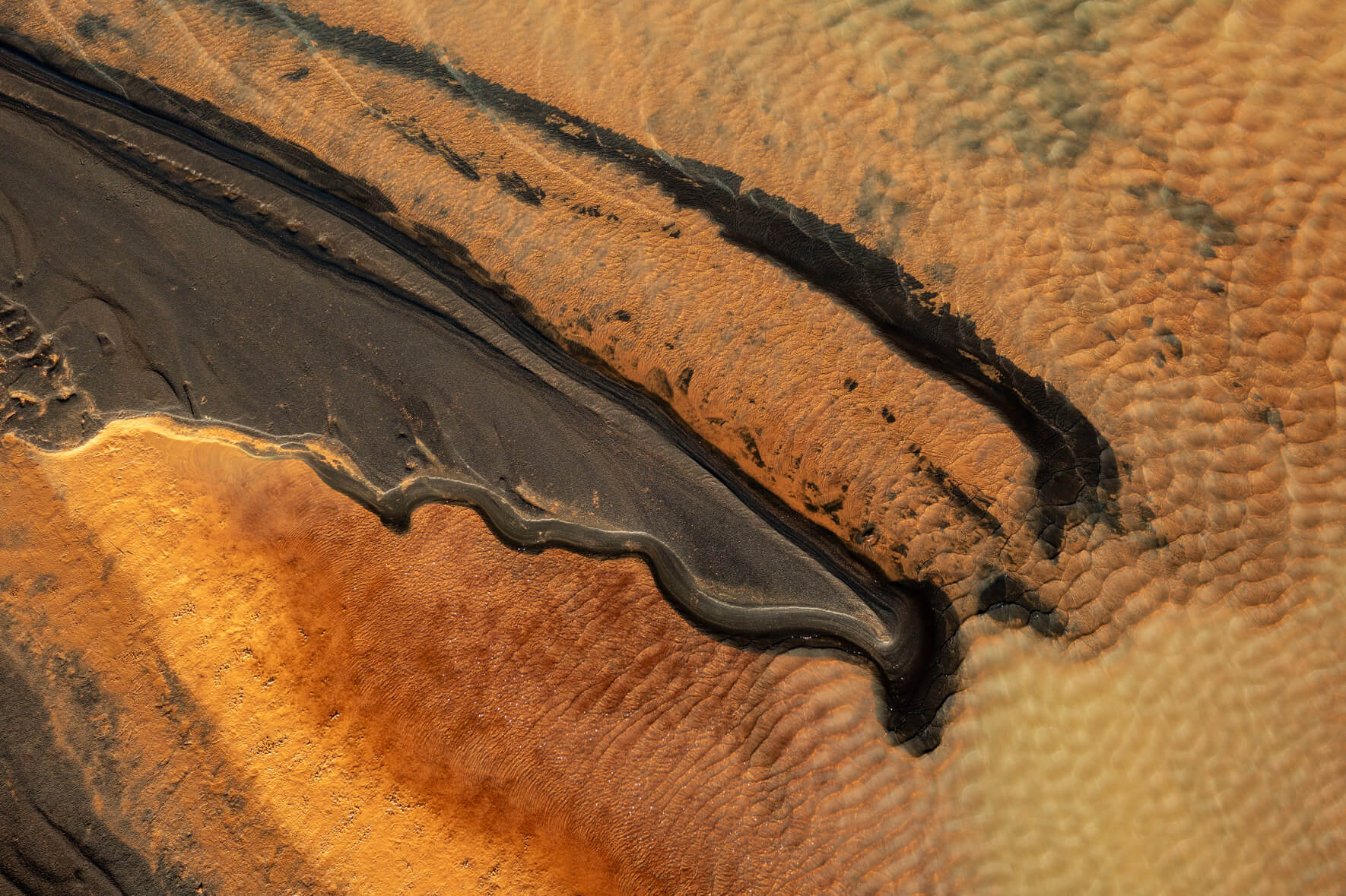 Aerial close-up of glacial meltwater mixing with sulphur compounds in Iceland