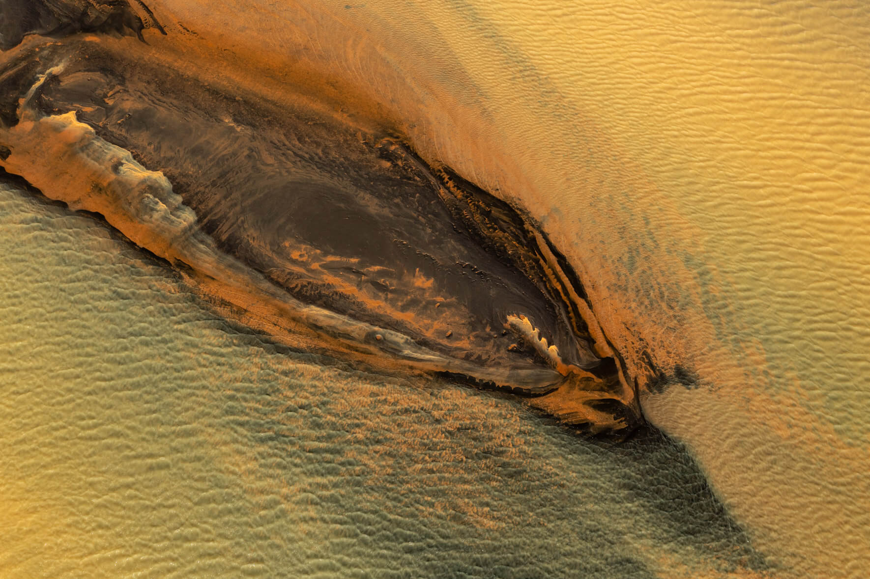 Aerial shot illustrating the interplay between geothermal features and river currents in Iceland