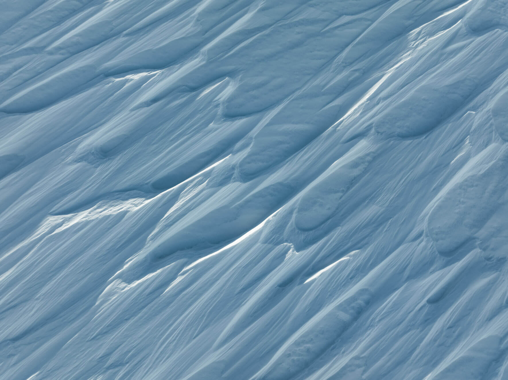 Abstract snow drift patterns shaped by wind in Norway’s Hardangervidda region