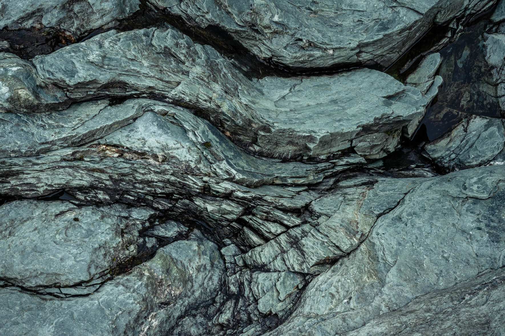 Fine rock pattern showing smooth mineral transitions and layered textures