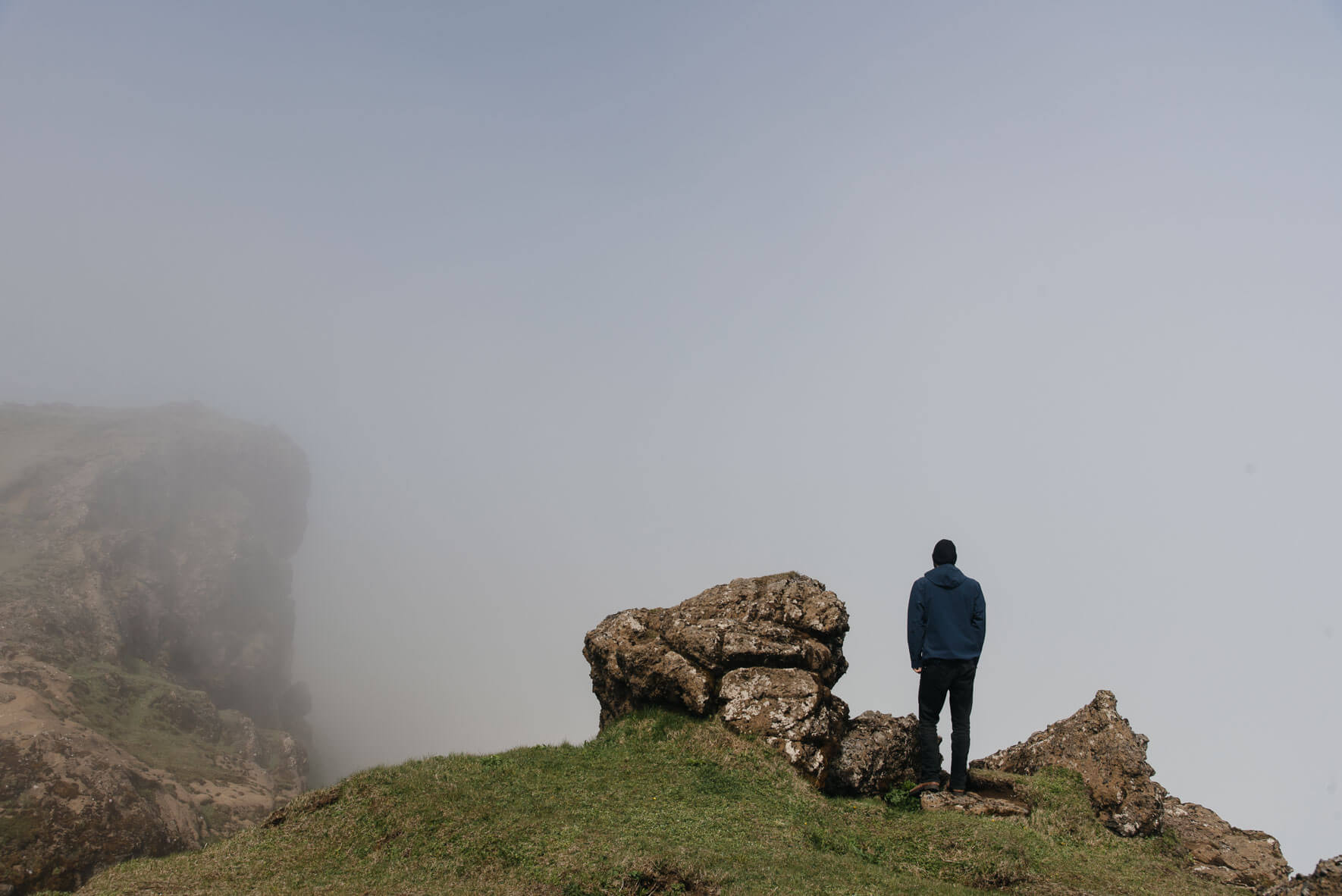 Man standing on Reynisfjall mountain on the south coast of Iceland