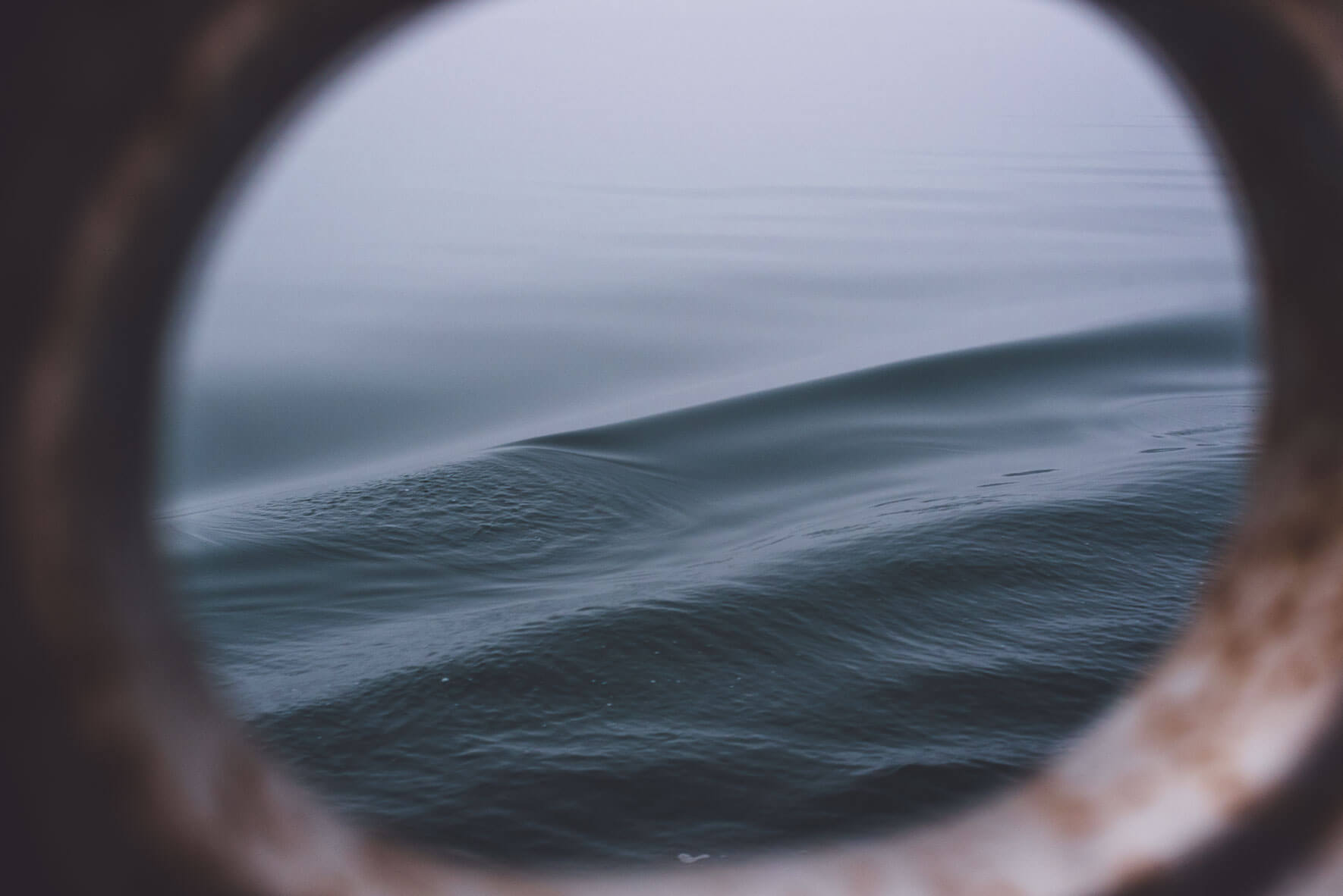 View through a porthole of the three-mast sailing ship Antigua