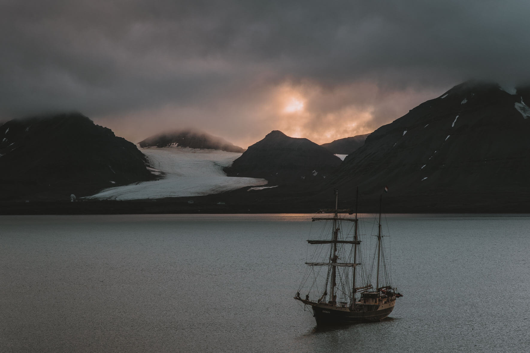 Sunset over Ny-Ålesund on Svalbard and the Dutch sailing ship Antigua