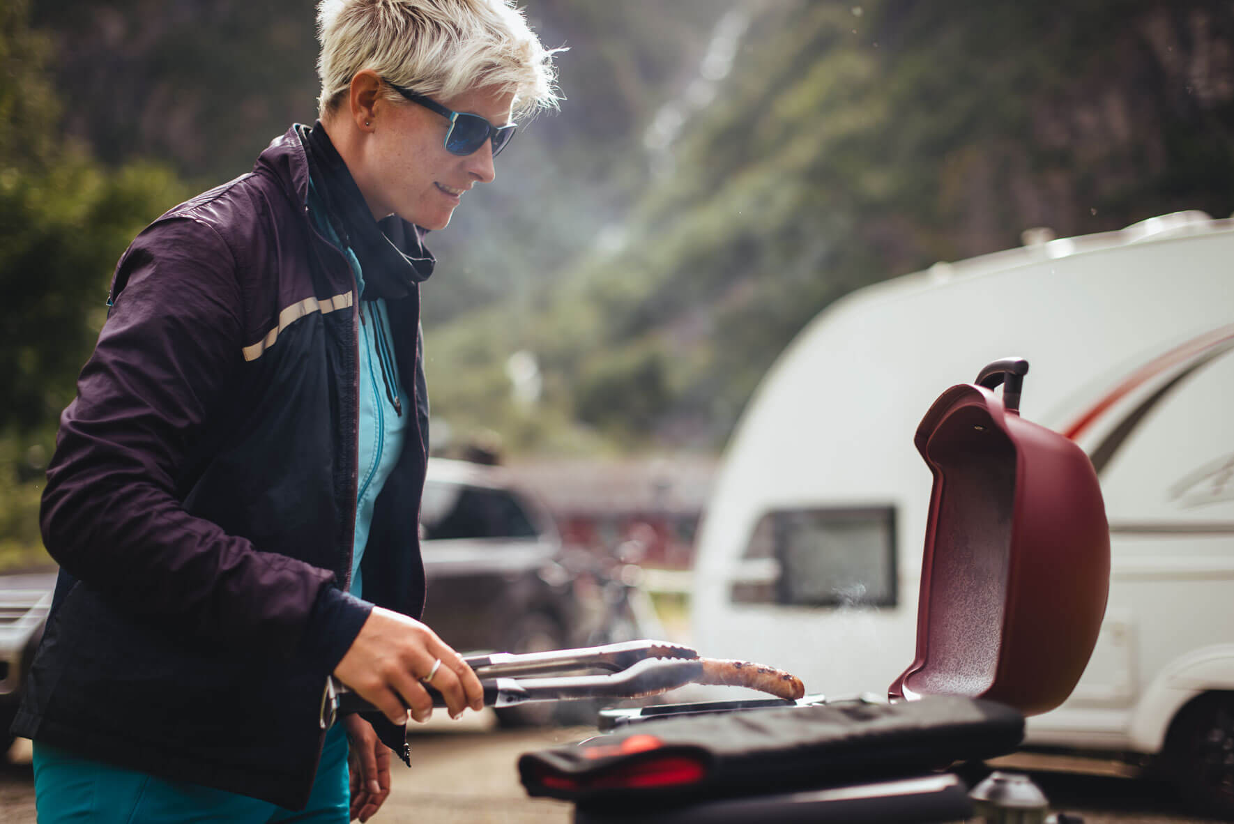 Woman on a campsite with Weber Q 1200 grill