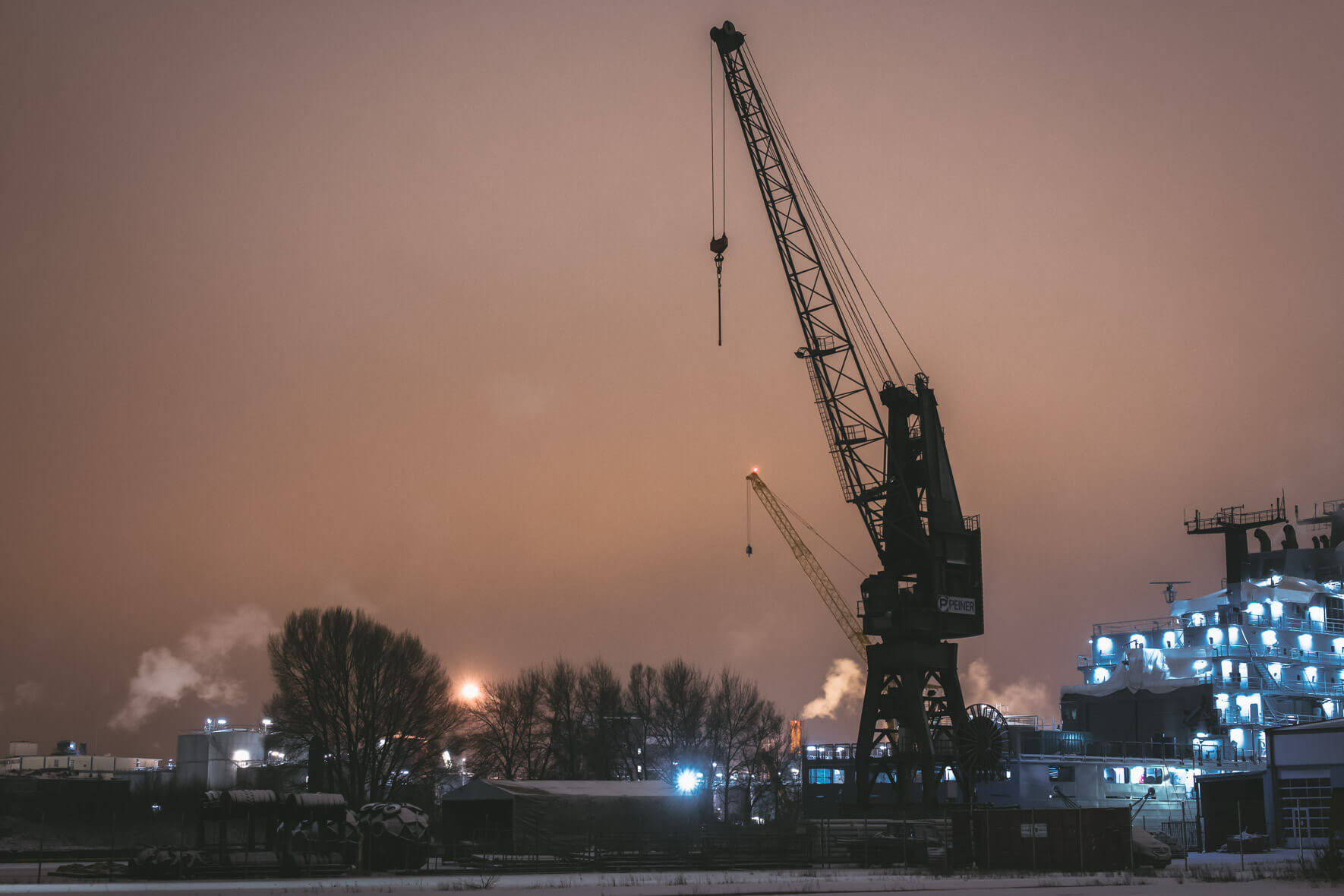 Container harbor Waltershof in Hamburg at night with snow