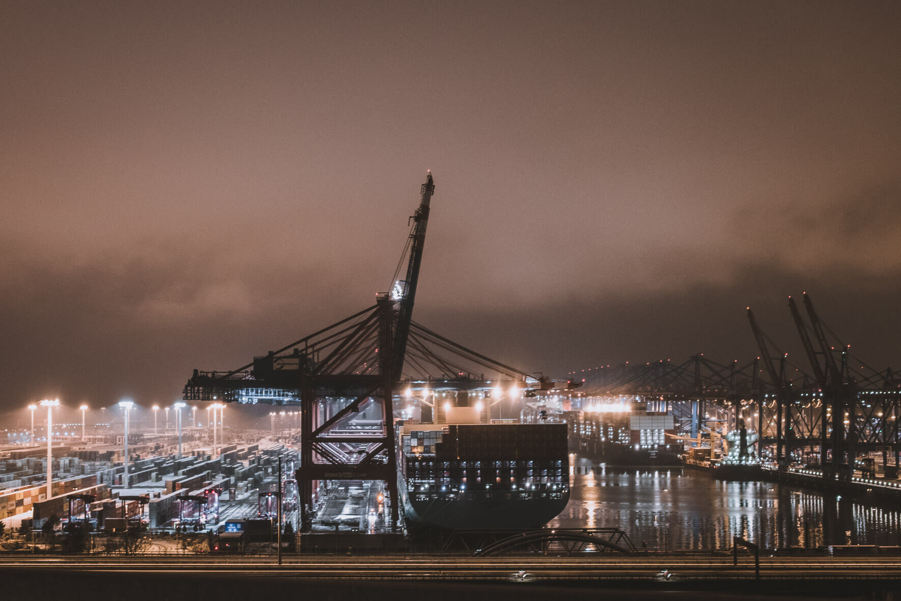 Old harbor crane at night in Hamburg