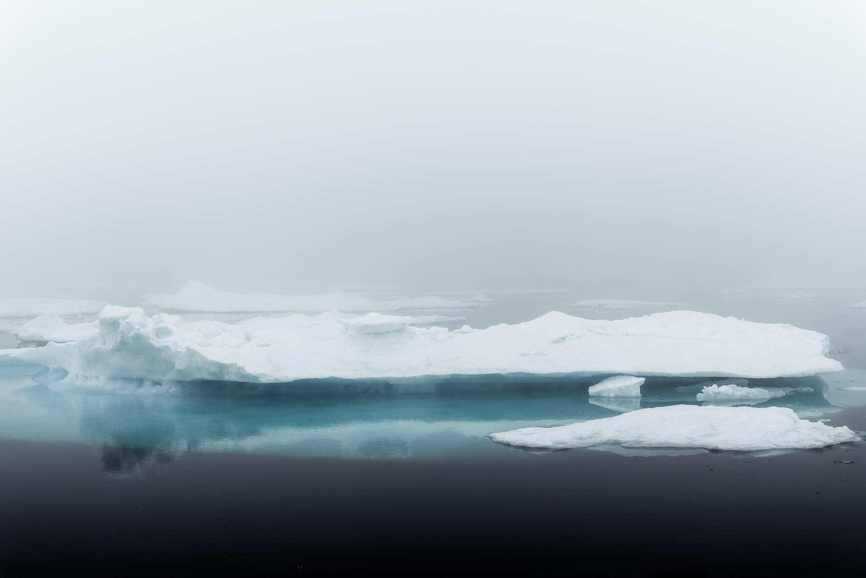 Soft light and foggy weather in Greenland with iceberg