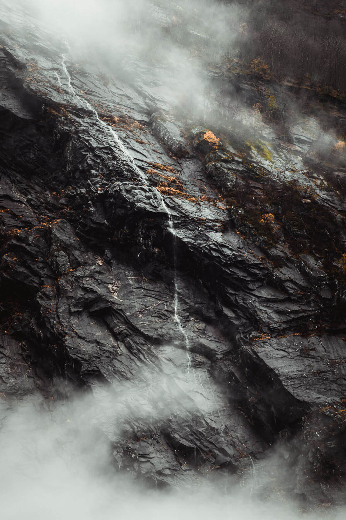 Dark rocks and waterfall in Jostedal, Norway