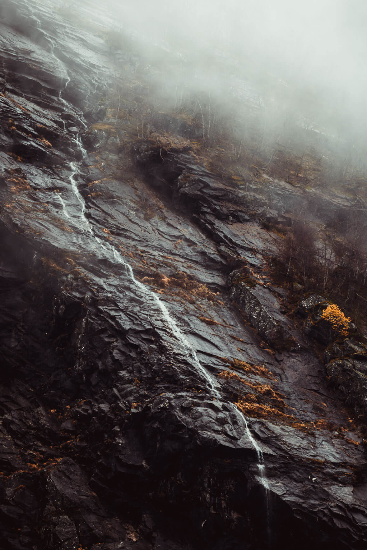 Waterfall coming down rocky mountain in Jostedal, Norway