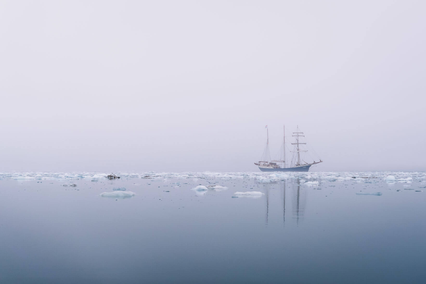 Sailing ship between icebergs on Svalbard (Spitsbergen)