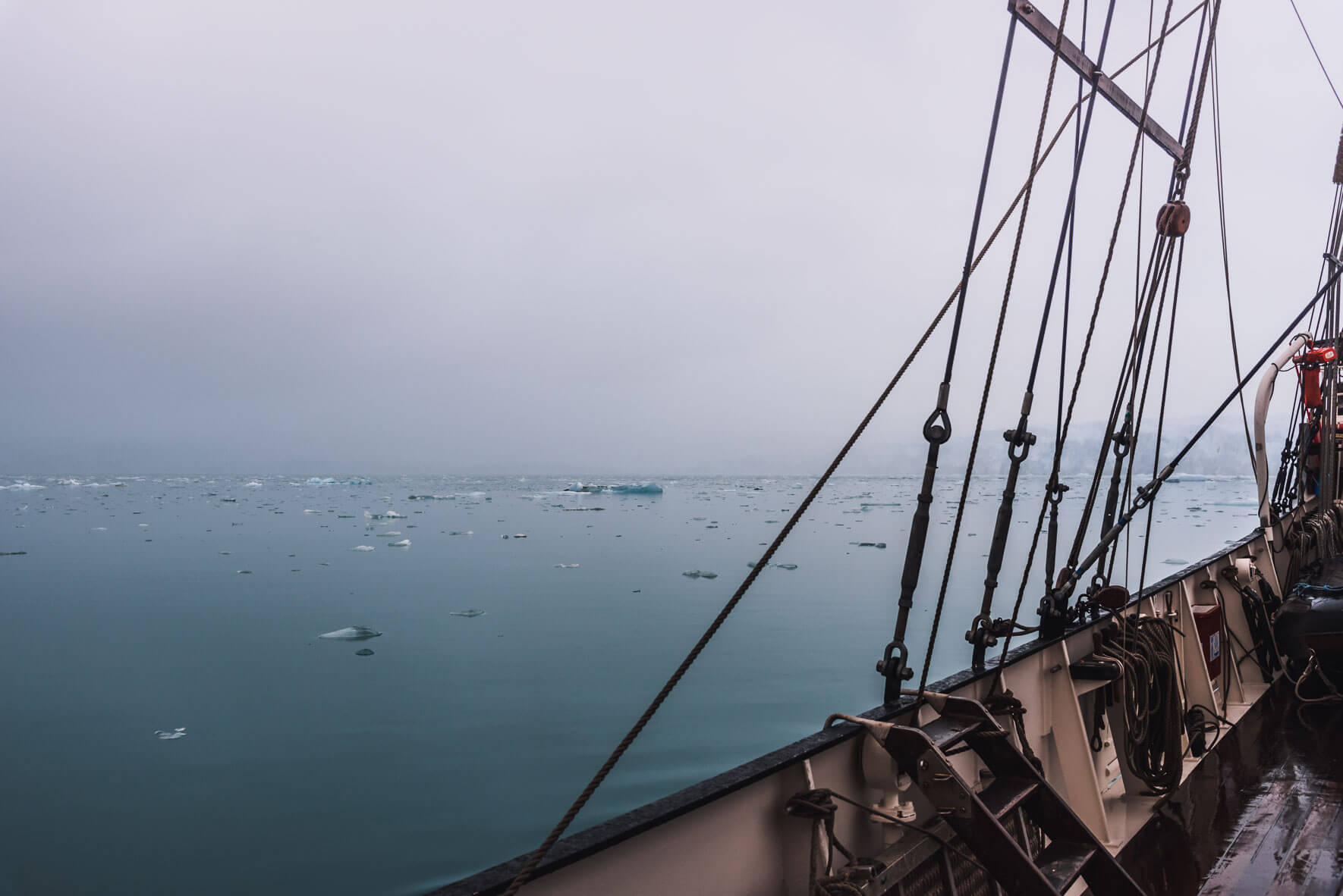 Sailing voyage between icebergs on Svalbard