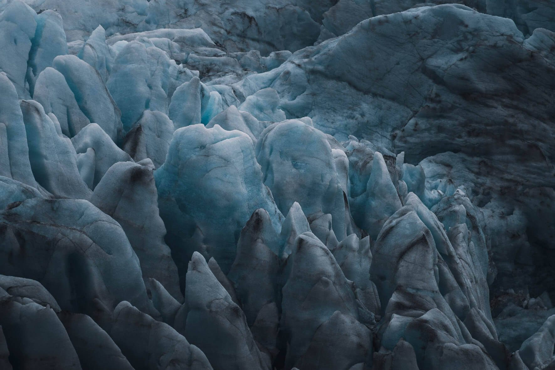 Closeup of glacier ice with dark deposits on the archipelago of Svalbard